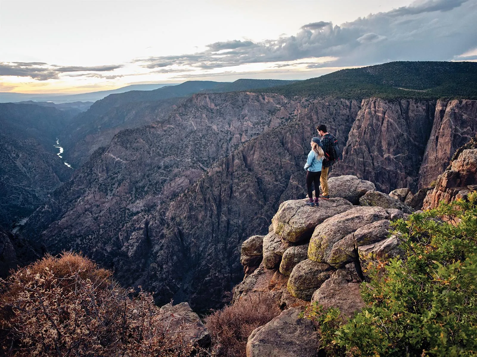 Summer sunset view at Black Canyon of the Gunnison showing golden light on canyon walls